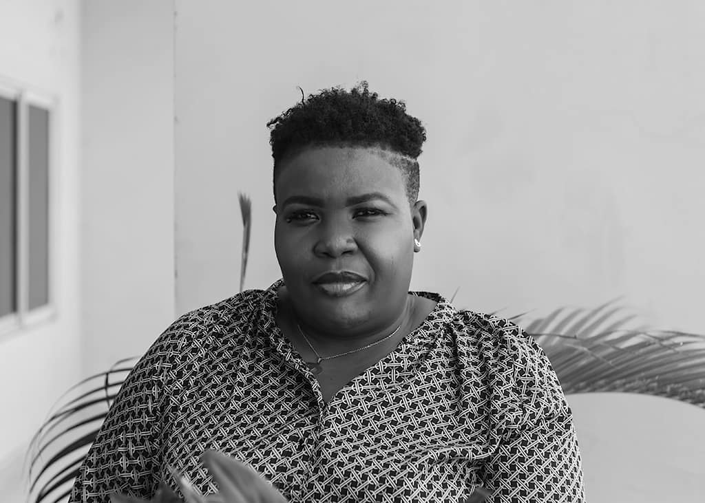 image of a woman with a quirky expression on her face. she is looking at the camera.