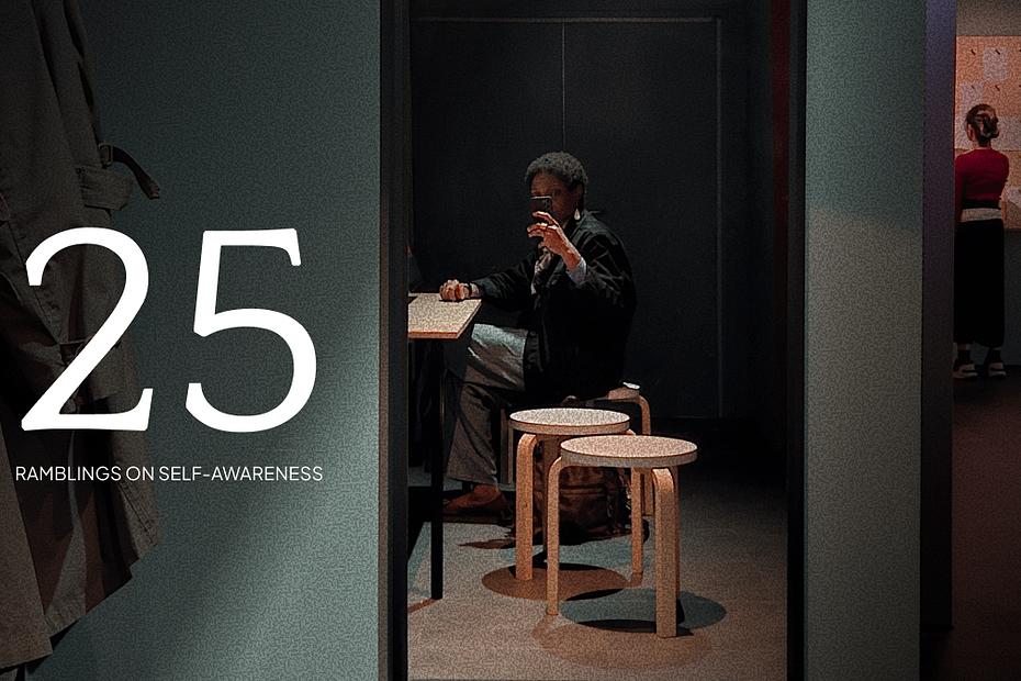 A dimly lit photo of Funmilayo sitting at a small table, taking a mirror selfie with a phone in an exhibition room. The number “25” is boldly displayed on the left, with the subtitle “Ramblings on Self-Awareness.” The mood is introspective and subdued, suggesting a personal essay or reflection piece.